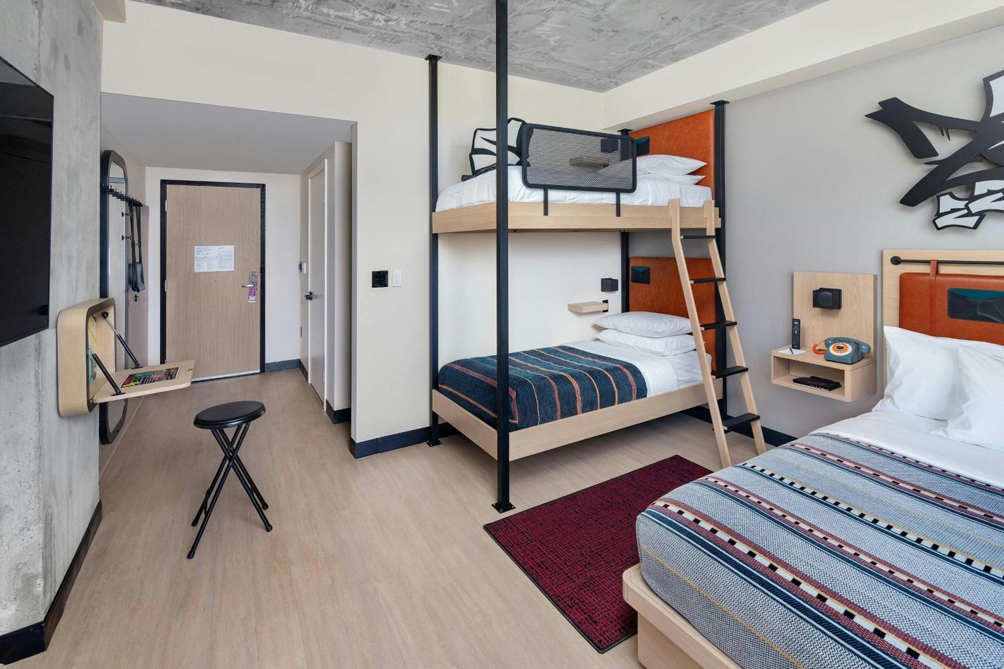 Room with One Queen Bed and Bunk Beds
